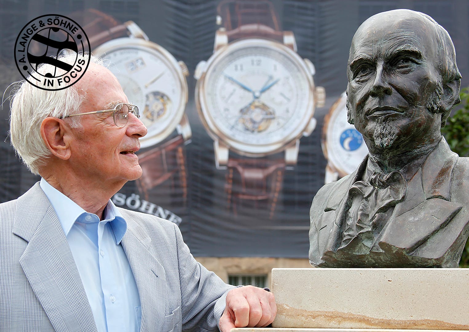 The late Walter Lange stands beside a bronze bust of his great-grandfather Ferdinand Adolph